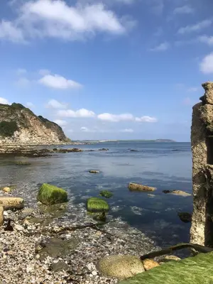 a view of the ocean with rocks in the water at The Chapel Guest House in St Austell