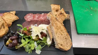 a plate of food with a sandwich and a salad at The Crown Inn in Lanlivery