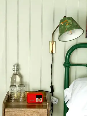 a lamp on a night stand next to a bed at The Crown Inn in Lanlivery