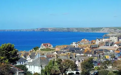 a town with houses and a large body of water at Stunning Two Bed Sea View Apartment with Pool & Gym in Newquay