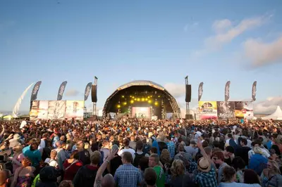 a large crowd of people standing in front of a concert at Stunning Two Bed Sea View Apartment with Pool & Gym in Newquay