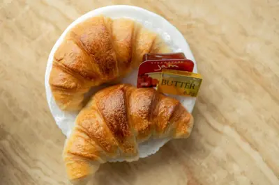 two croissants and a jar of butter on a plate at Anacapri in Falmouth