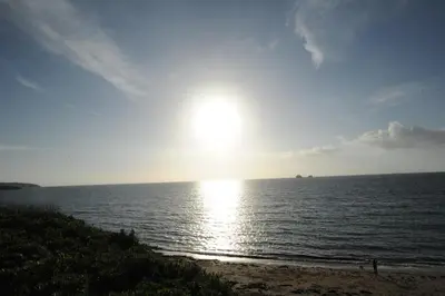 a sun setting over the ocean on a beach at Anacapri in Falmouth