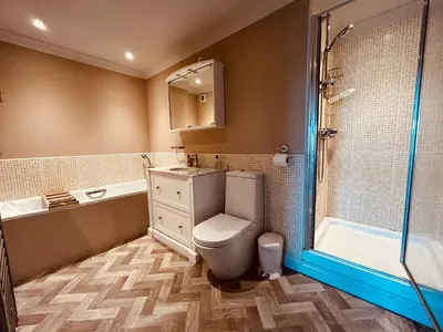 a bathroom with a toilet and a sink and a shower at Pentire Headland Retreat in Newquay