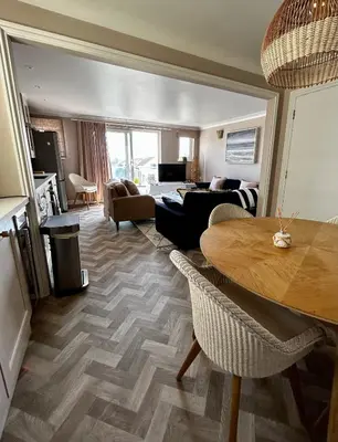 a living room with a table and a couch at Pentire Headland Retreat in Newquay