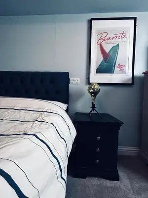 a bedroom with a bed and a table with a lamp at Pentire Headland Retreat in Newquay