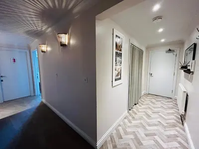 a hallway with white walls and a ceiling at Pentire Headland Retreat in Newquay