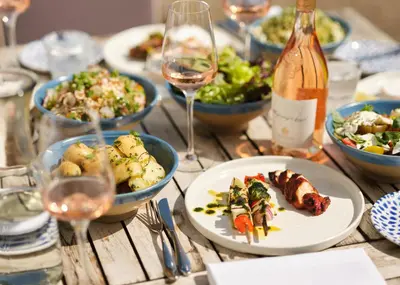 a table with plates of food and glasses of wine at The St Enodoc Hotel in Wadebridge