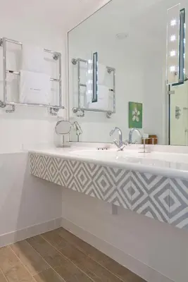 a bathroom with two sinks and a mirror at The St Enodoc Hotel in Wadebridge