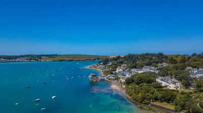 an aerial view of a beach with boats in the water at The St Enodoc Hotel in Wadebridge