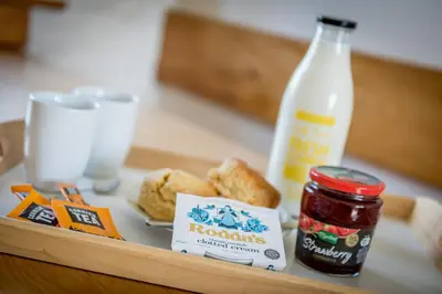 a tray with food and a bottle of milk at Cargurra Farm in Boscastle