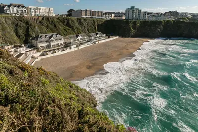 an aerial view of a beach and the ocean at Tolcarne Beach Cabins in Newquay