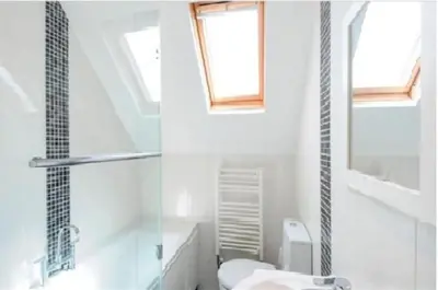 a bathroom with a sink and a toilet and a window at Number 9 Rosemorran in St Ives