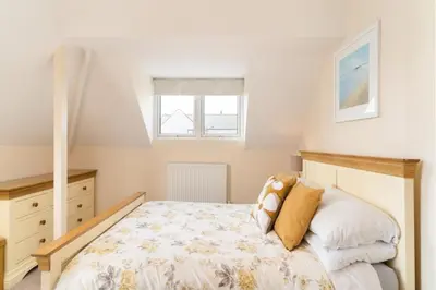 a bedroom with a bed and a window at Number 9 Rosemorran in St Ives