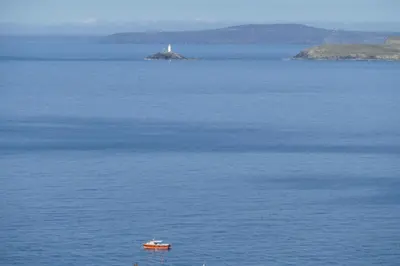 a boat in the middle of a large body of water at Number 9 Rosemorran in St Ives