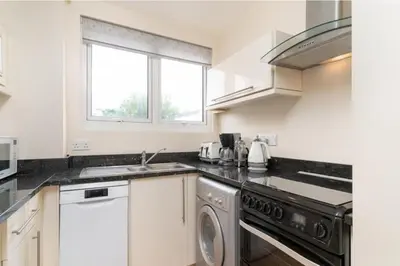 a kitchen with a sink and a dishwasher at Number 9 Rosemorran in St Ives