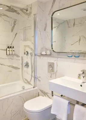 a bathroom with a toilet and a sink and a shower at Harbour Hotel Fowey in Fowey