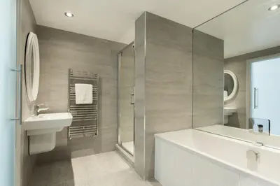 a bathroom with a tub and a sink and a shower at The Idle Rocks in Saint Mawes