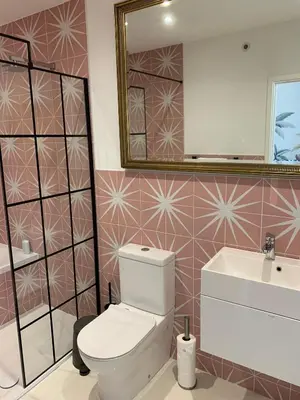 a bathroom with a toilet and a sink and a mirror at Porth Beach Hotel in Newquay