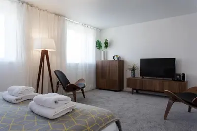 a hotel room with two beds and a flat screen tv at Porth Beach Hotel in Newquay