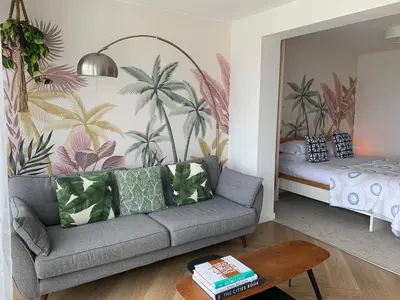 a living room with a couch and a bed at Porth Beach Hotel in Newquay