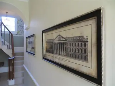 a framed picture of a building on a wall at Coswarth House with breakfast at Rick Stein's in Padstow