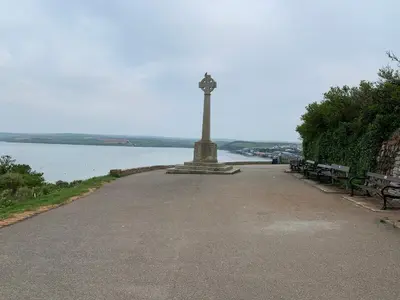 a monument next to two benches and a body of water at Coswarth House with breakfast at Rick Stein's in Padstow