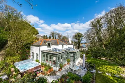 an aerial view of a house with a swimming pool at Carbis Bay and Spa Hotel in St Ives
