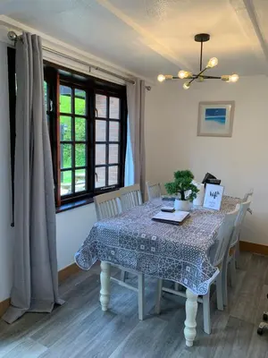 a dining room with a table and chairs and a window at Cornwall holiday homes in Hayle