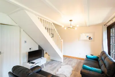 a living room with a couch and a tv at Cornwall holiday homes in Hayle