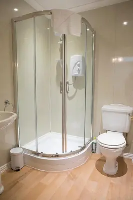 a bathroom with a shower and a toilet at Braemar in Falmouth