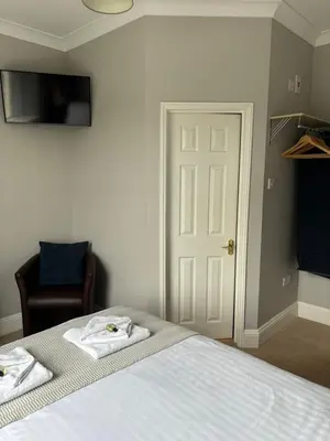 a bedroom with a bed with towels on it at Braemar in Falmouth