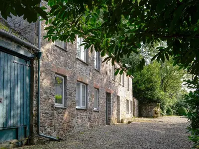 a brick building with a door on a street at Every in Saint Kew