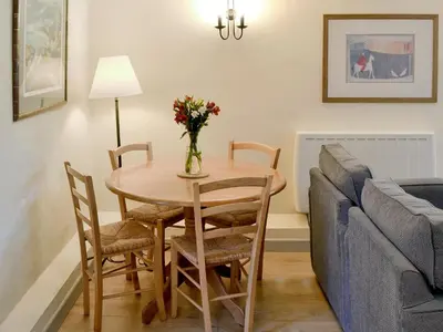 a living room with a table and a couch at Paget in Saint Kew