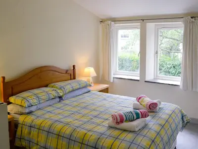 a bedroom with a bed with two pillows on it at Paget in Saint Kew