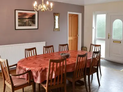 a dining room with a table and chairs at Tregoona in Crantock