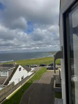 a view of the ocean from a window of a house at 6 Ocean Gate apartment in Newquay