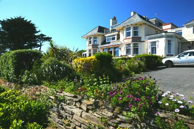 a house with a car parked in front of it at Porth Avallen Hotel in St Austell
