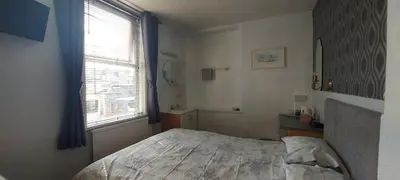a small bedroom with a bed and a window at Invernook in Newquay