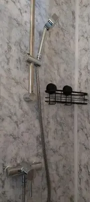 a shower in a bathroom with a shower head at Invernook in Newquay