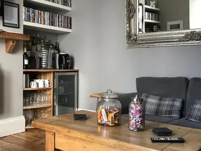 a living room with a table and a couch at St Bernards in Newquay
