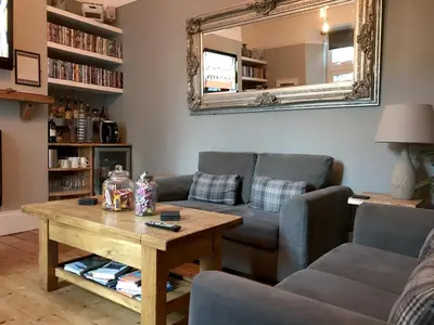 a living room with a couch and a table at St Bernards in Newquay