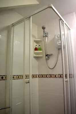 a shower with a glass door in a bathroom at Harrington Guest House in Newquay