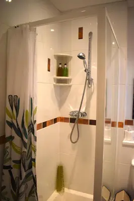 a shower in a bathroom with a shower curtain at Harrington Guest House in Newquay
