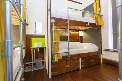 a bedroom with two bunk beds in a room at Cohort Hostel in St Ives