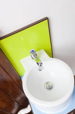 a bathroom with a white sink and a mirror at Cohort Hostel in St Ives