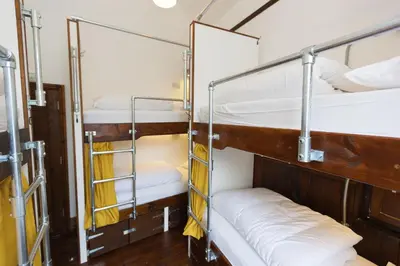 a room with bunk beds on a cruise ship at Cohort Hostel in St Ives