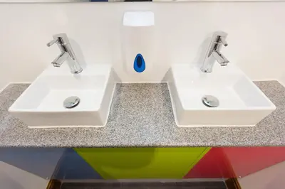 two sinks on a counter in a bathroom at Cohort Hostel in St Ives