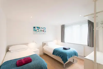 a bedroom with two beds and a window at Camana in St Ives