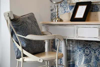a chair sitting next to a desk in a room at Padstow Townhouse in Padstow